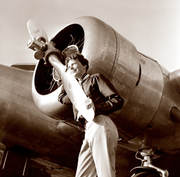 Amelia Earhart standing in front of her plane in 1937.